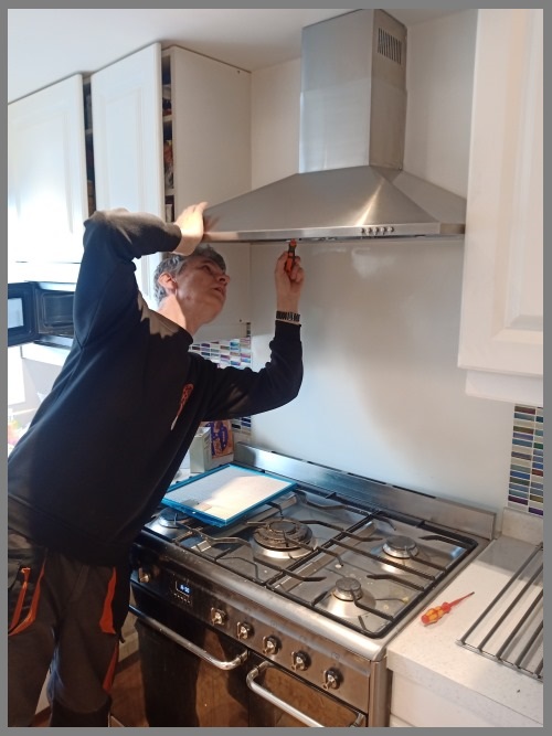 Kitchen hood installer in Coventry working safely on commercial ventilation